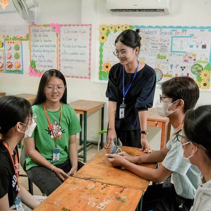 Students learning together with a VOTY trainer in a classroom